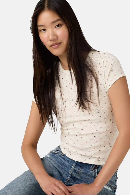 Wit T-shirt met korte mouwen van Levi's®, met een delicaat bloemenpatroon en gedragen met een spijkerbroek.