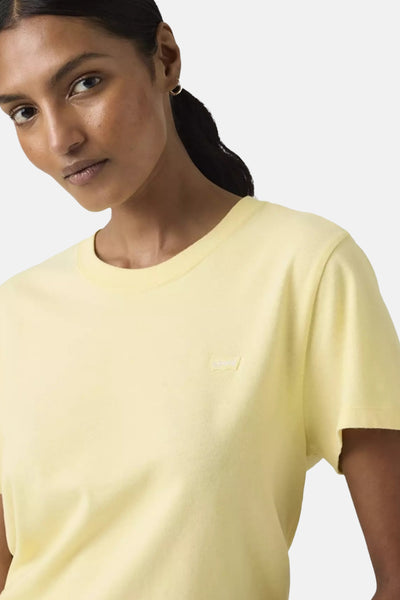 T-shirt jaune à manches courtes de Levi's® porté par un mannequin, avec boucle d'oreille dorée visible.