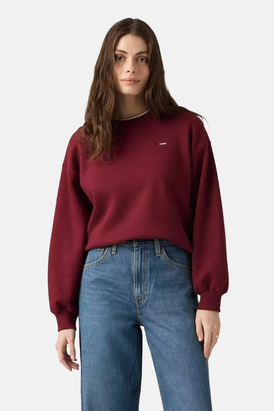 Bordeaux crewneck sweatshirt by Levi's with small chest logo, worn with blue jeans, front view