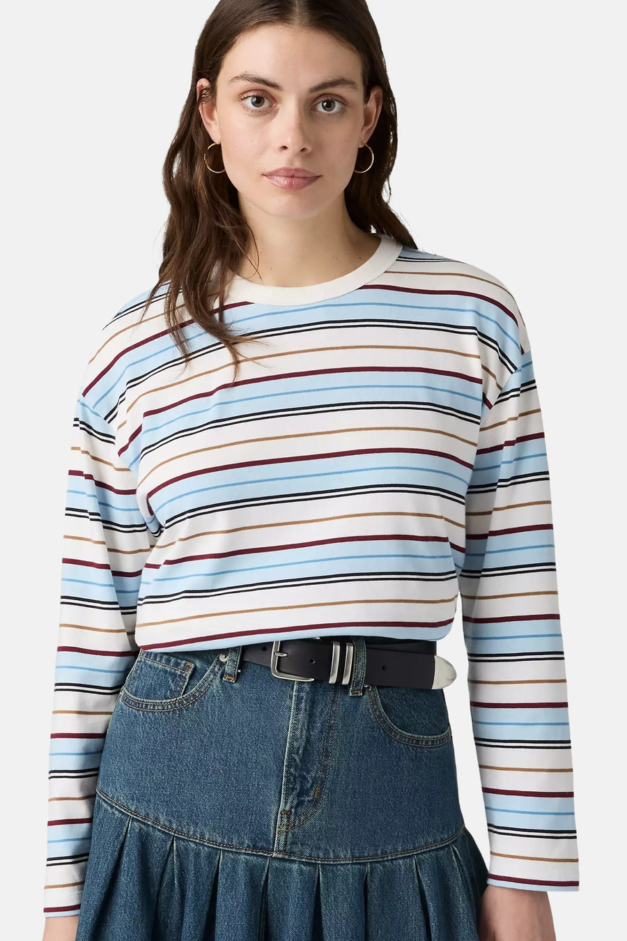 Blue long-sleeve striped t-shirt with white, red, and brown horizontal bands, worn with denim skirt and black belt, front view