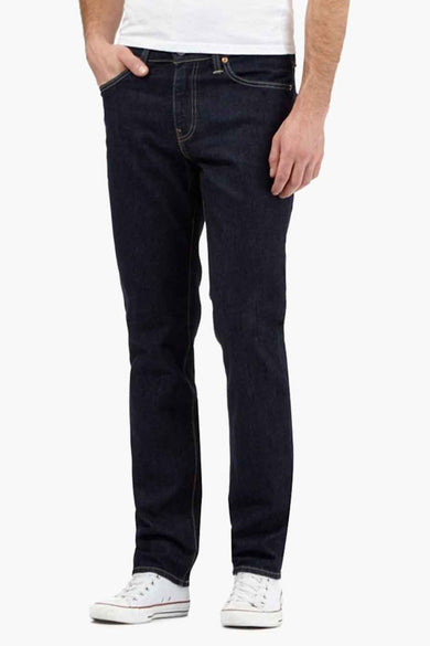 Dark blue slim-fit denim jeans by 511™, front view on model wearing white t-shirt and sneakers