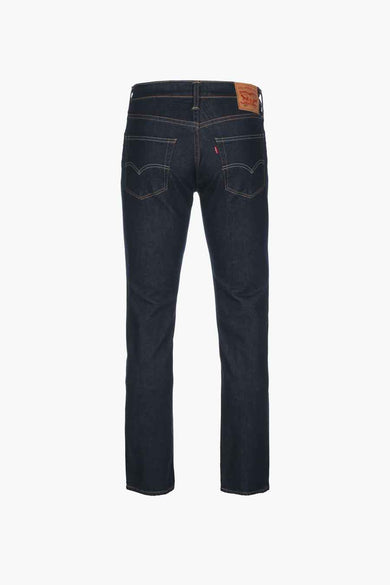 Dark blue slim-fit denim jeans by 5.11, back view with brown leather patch and orange stitching details