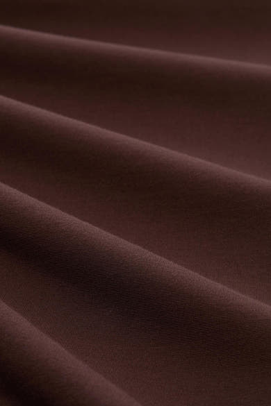 Brown five-pocket women's seasonal trouser fabric close-up, soft textured material with gentle folds and rich color tone