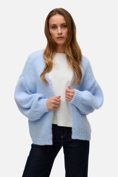 Cardigan bleu clair de VERO MODA, porté sur un t-shirt blanc et un jean foncé.
