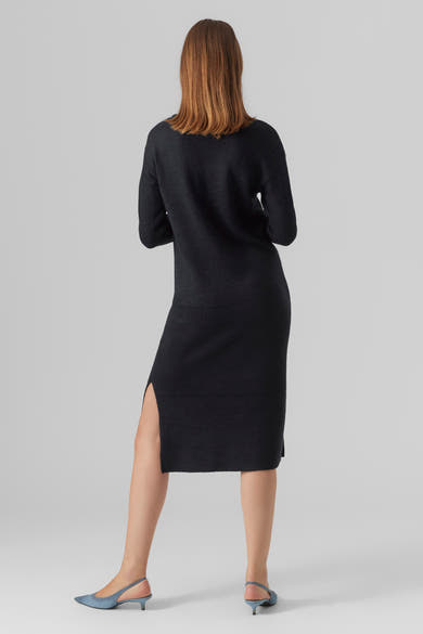 Zwarte midi-jurk van VERO MODA, met een zijsplit en gedragen met lichtblauwe pumps.