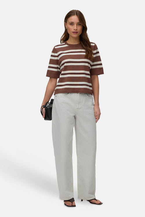 Cocoa brown striped O-neck pullover with white horizontal stripes, worn with light gray jeans and black sandals, front view.