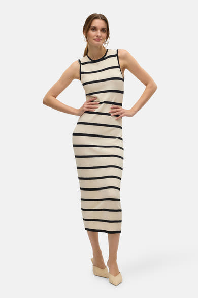 Zwart-ecru gestreepte jurk van Vero Moda, nauwsluitend model tot op de knie, gedragen met beige muiltjes.