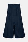 Pantalon ample bleu par VERO MODA, avec une texture légèrement froissée et des plis structurés à la taille.