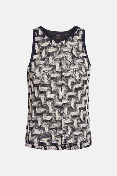 Blouse bleue sans manches de Vero Moda, motif géométrique ajouré.
