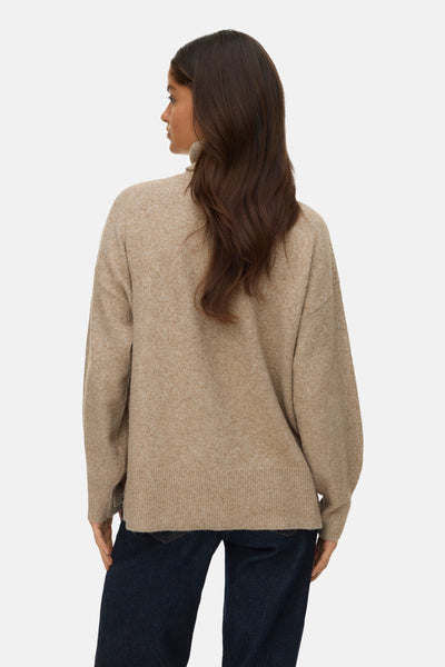 Pull à col roulé beige de VERO MODA®, porté avec un jean foncé, vue de dos.

