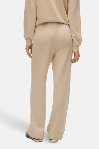 Pantalon écru de VERO MODA, coupe droite, porté avec un haut assorti, vue de dos.