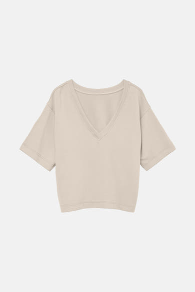 T-shirt écru à manches courtes de VERO MODA, coupe ample et décolleté en V.