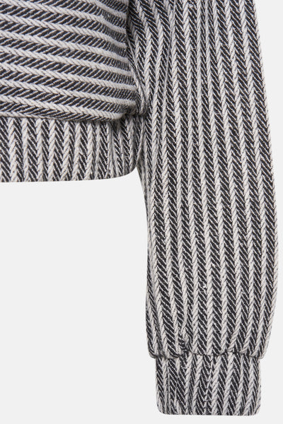 Korte zwarte jas van VERO MODA met getextureerd visgraatpatroon en lange mouwen.