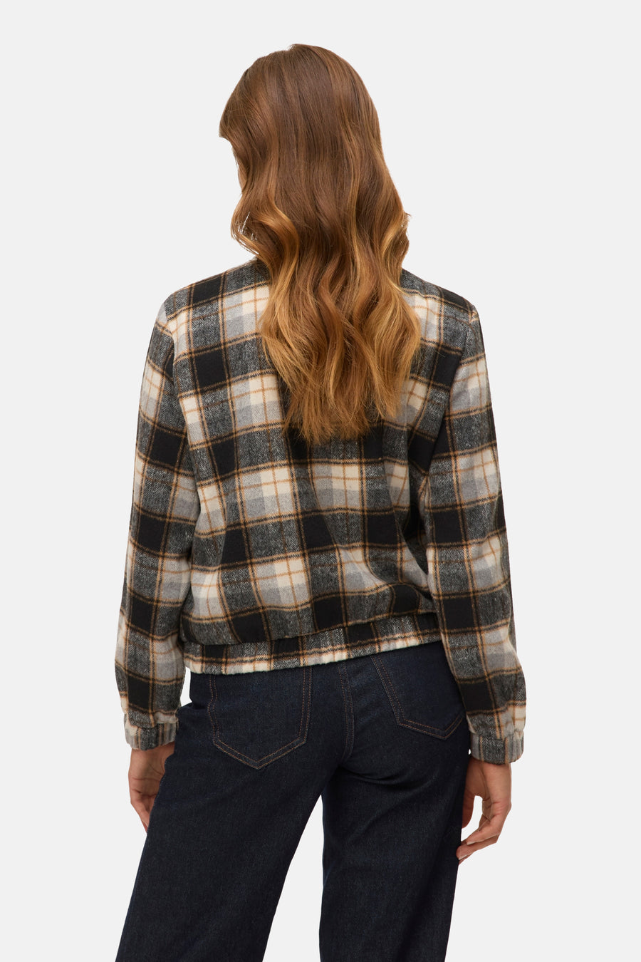 Korte meerkleurige jas van VERO MODA, geruit en met lange mouwen, gedragen met een donkerblauwe jeans.