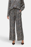 Multikleurige wijde broek van VERO MODA, met zebraprint, gedragen met bruine hakken.