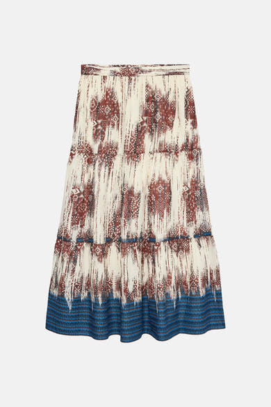 Jupe longue multicolore de VERO MODA® à motif abstrait crème et marron, avec une large bordure bleue imprimée au bas.
