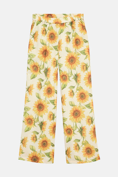 Pantalon coloré jaune de VERO MODA®, imprimé avec des motifs de tournesols.
