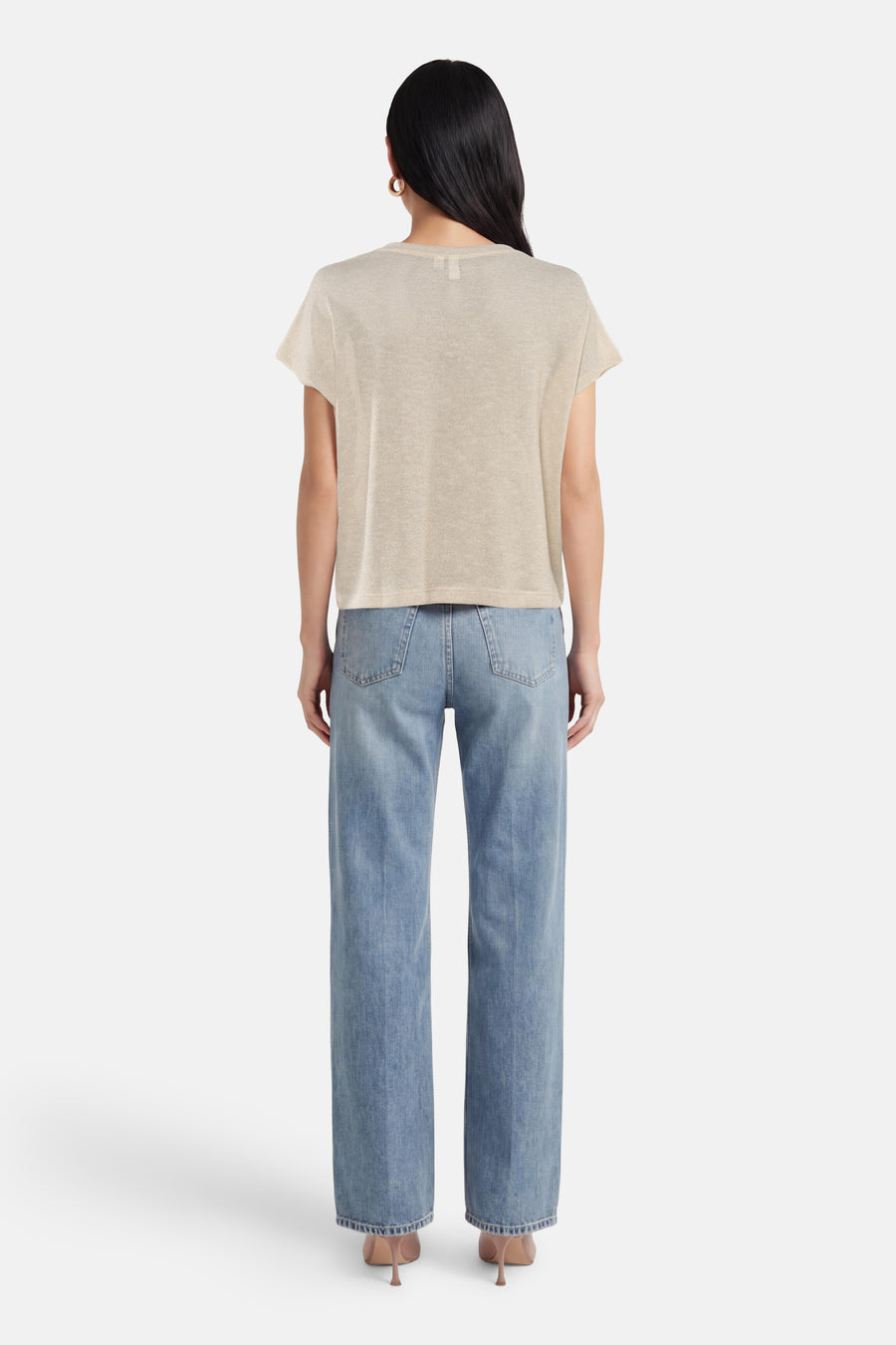 T-shirt beige à manches courtes de VERO MODA, porté avec un jean bleu taille haute et des escarpins.