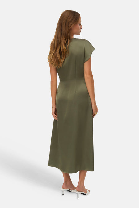 Robe kaki par VERO MODA®, coupe midi fluide, manches courtes, avec des sandales blanches à talons aiguilles.