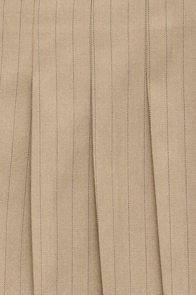 Beige pleated short skirt with fine vertical stripes, textured fabric, close-up view
