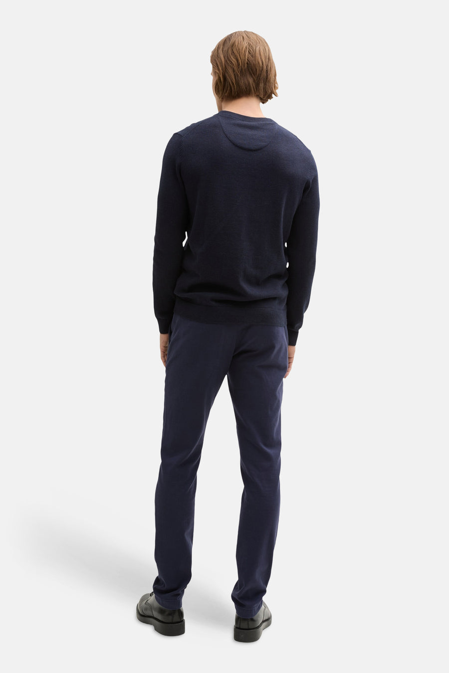 Navy blue chinos by Tom Tailor, shown from back view on model wearing dark sweater and black shoes, slim fit with clean finish
