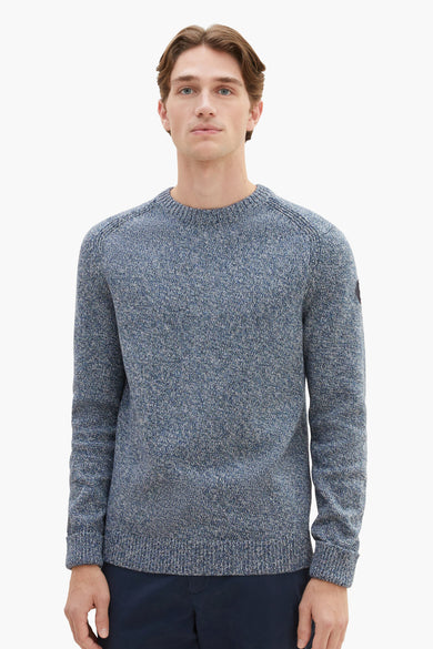 Blue marled crewneck sweater with ribbed cuffs and hem, worn by model in front view, textured knit fabric, small patch on sleeve