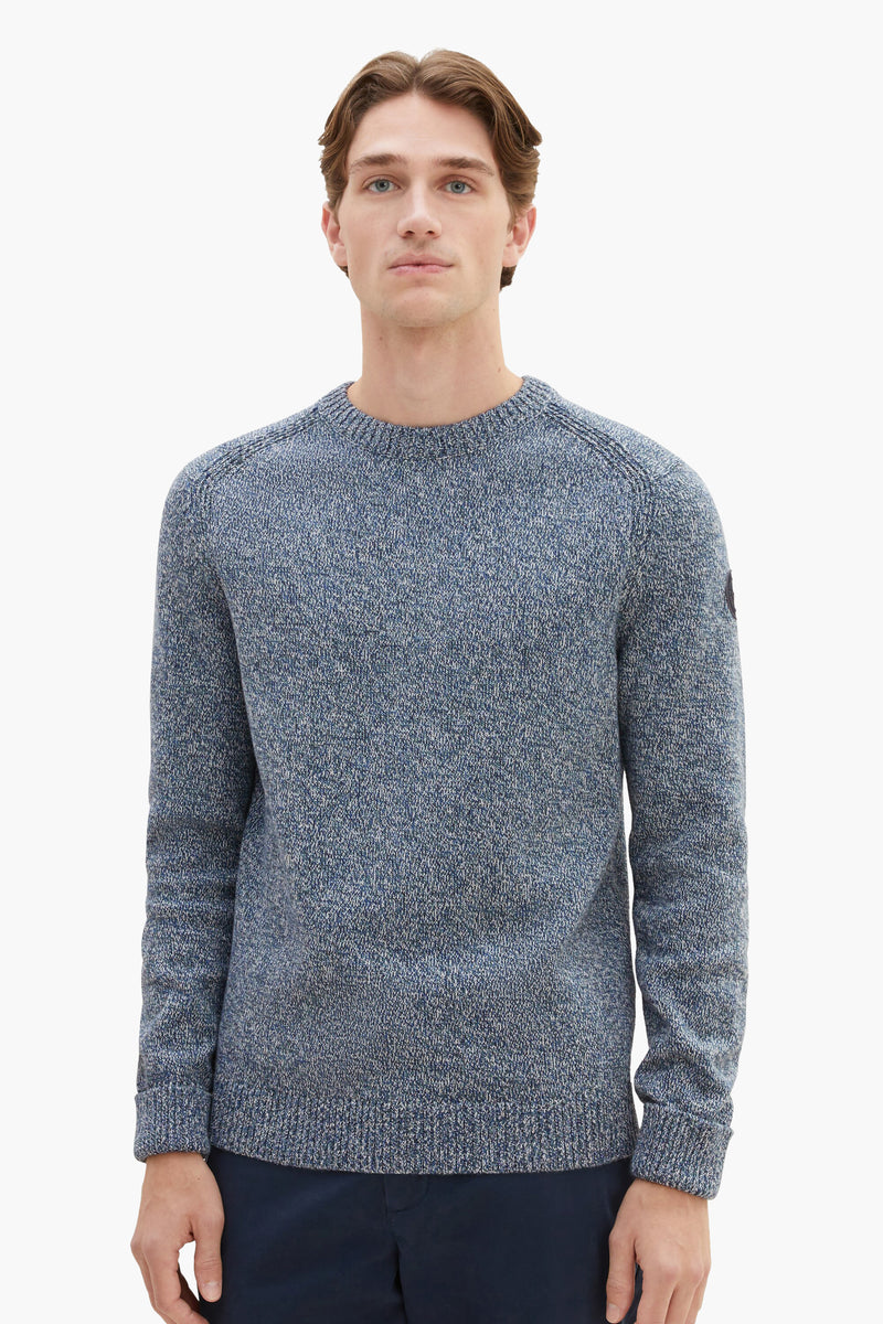 Blue marled crewneck sweater with ribbed cuffs and hem, worn by model in front view, textured knit fabric, small patch on sleeve