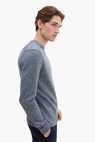 Blue marled crewneck sweater with textured knit, side view on model wearing dark pants