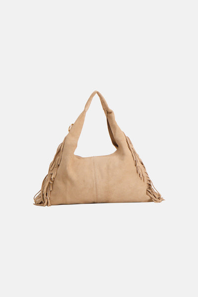 Sac à bandoulière beige Access® avec finitions franges décoratives sur les côtés.