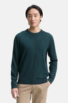 Groene trui met ronde hals, van Tom Tailor, gedragen met een effen beige broek.