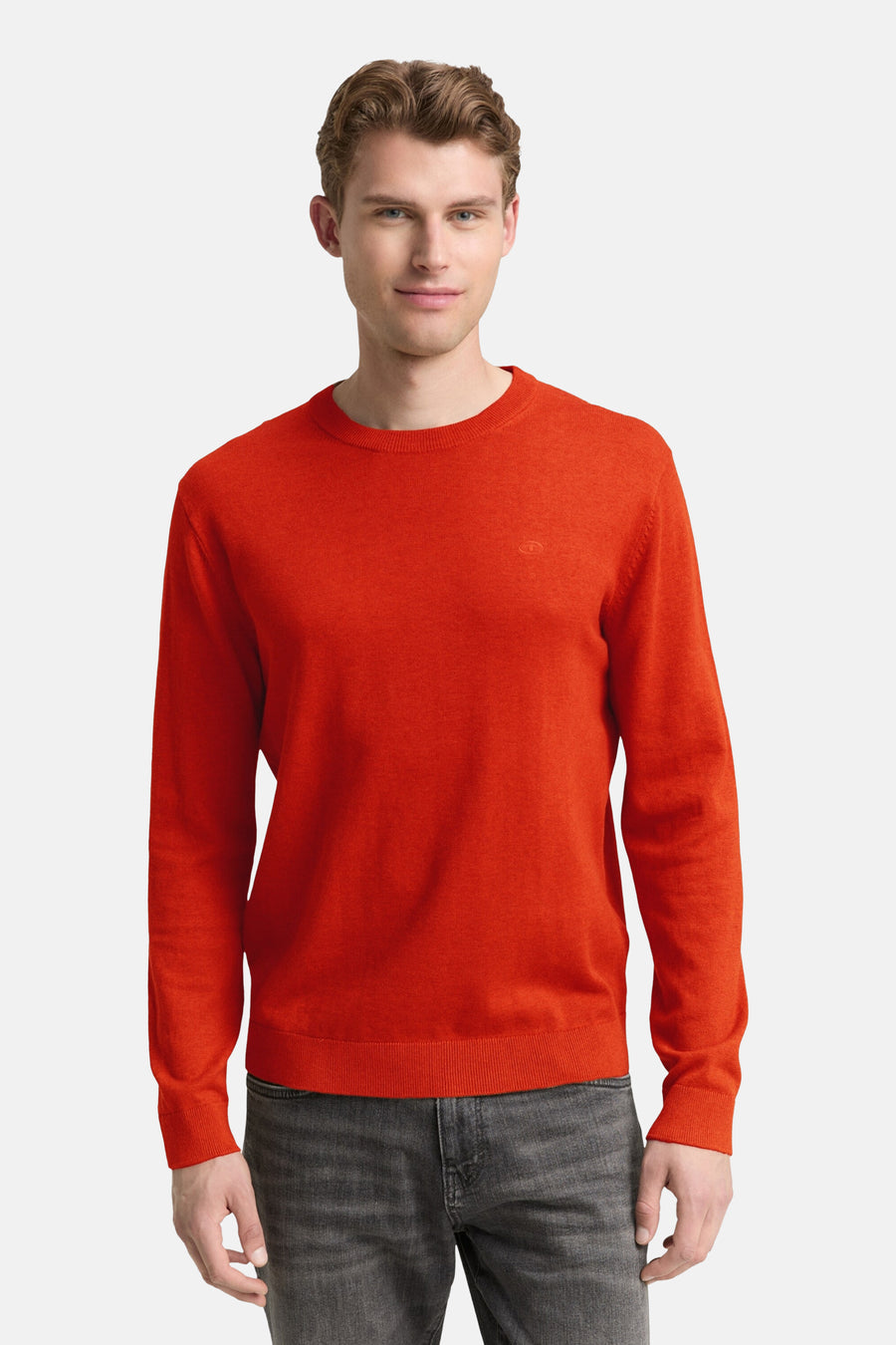 Pull à col rond orange de Tom Tailor, en maille fine, porté avec un jean gris délavé.