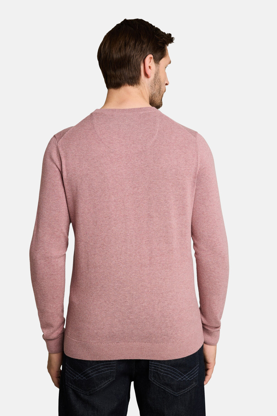 Rose-colored crew neck sweater with ribbed hem and cuffs, back view on model wearing dark jeans