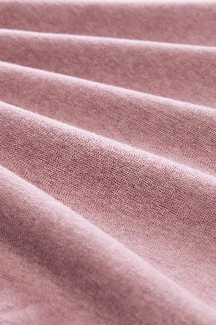 Rose-colored O-neck pullover with soft textured knit, close-up view showing fabric folds and gentle sheen