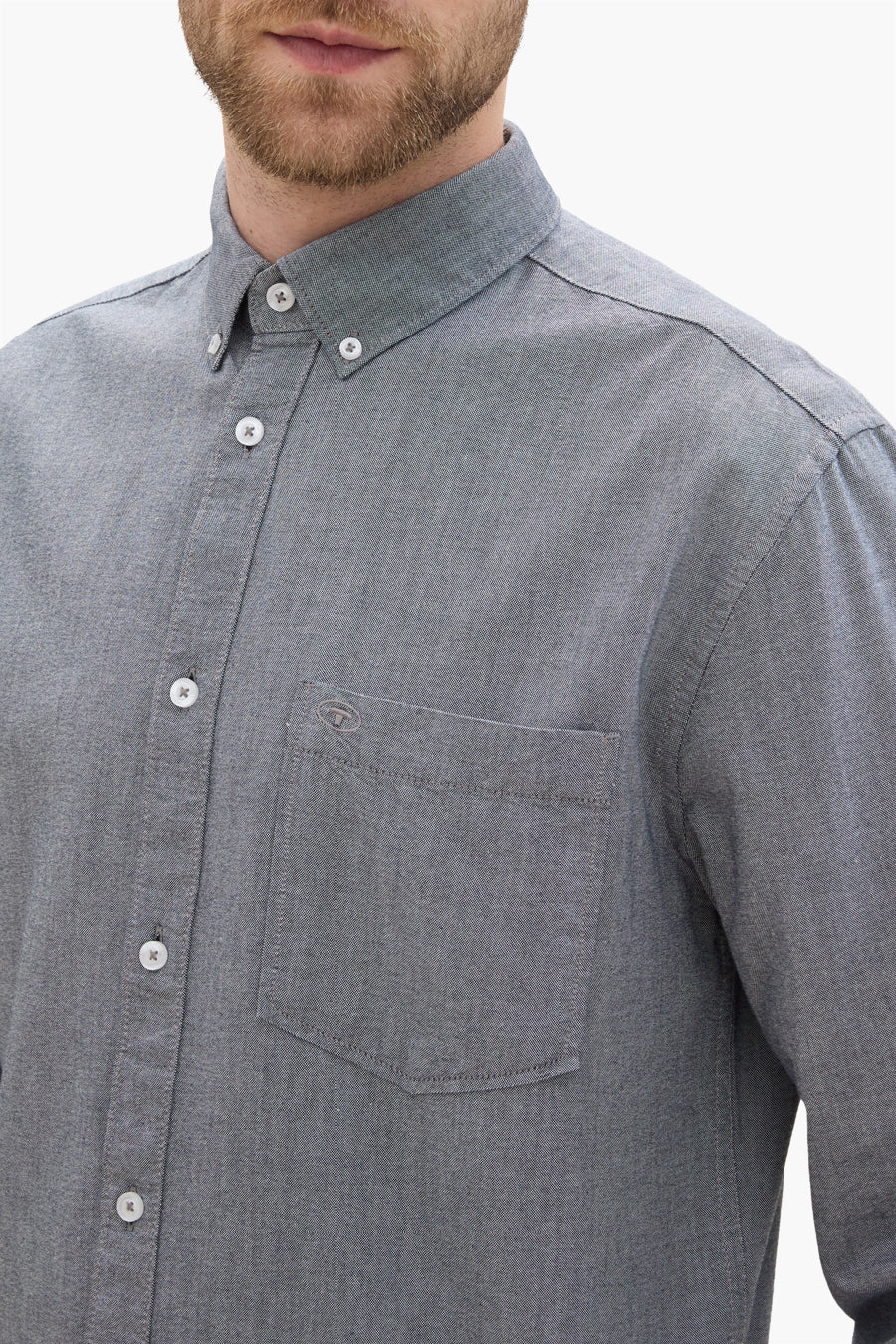 Chemise à manches longues bleue de Tom Tailor, avec poche poitrine et boutons blancs.