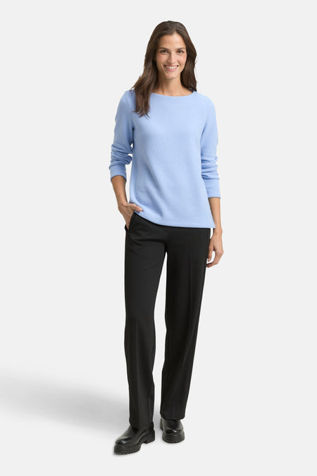 Ronde hals trui blauw van Tom Tailor, gedragen met een zwarte broek en leren laarzen.