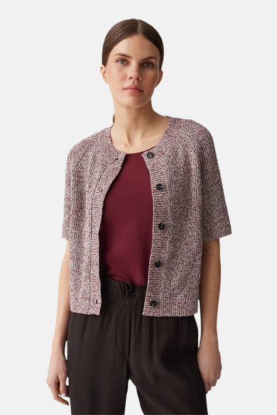Gilet rouge chiné de OPUS, porté sur un t-shirt bordeaux et un pantalon marron foncé texturé.