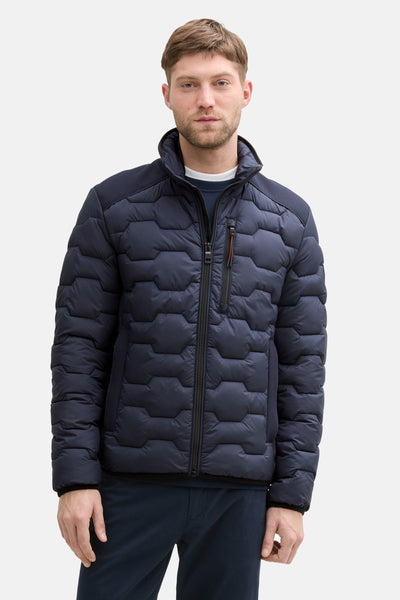 Veste courte bleue de Tom Tailor avec motif géométrique hexagonal et fermeture éclair centrale.