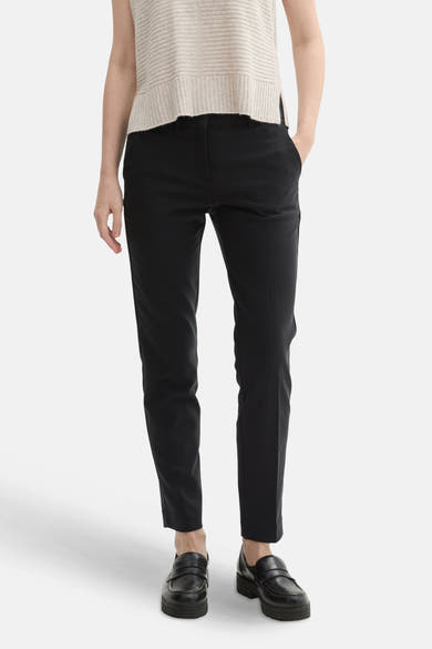 Zwarte broek van Tom Tailor, slim fit, gedragen met een geribde gebreide trui en loafers.