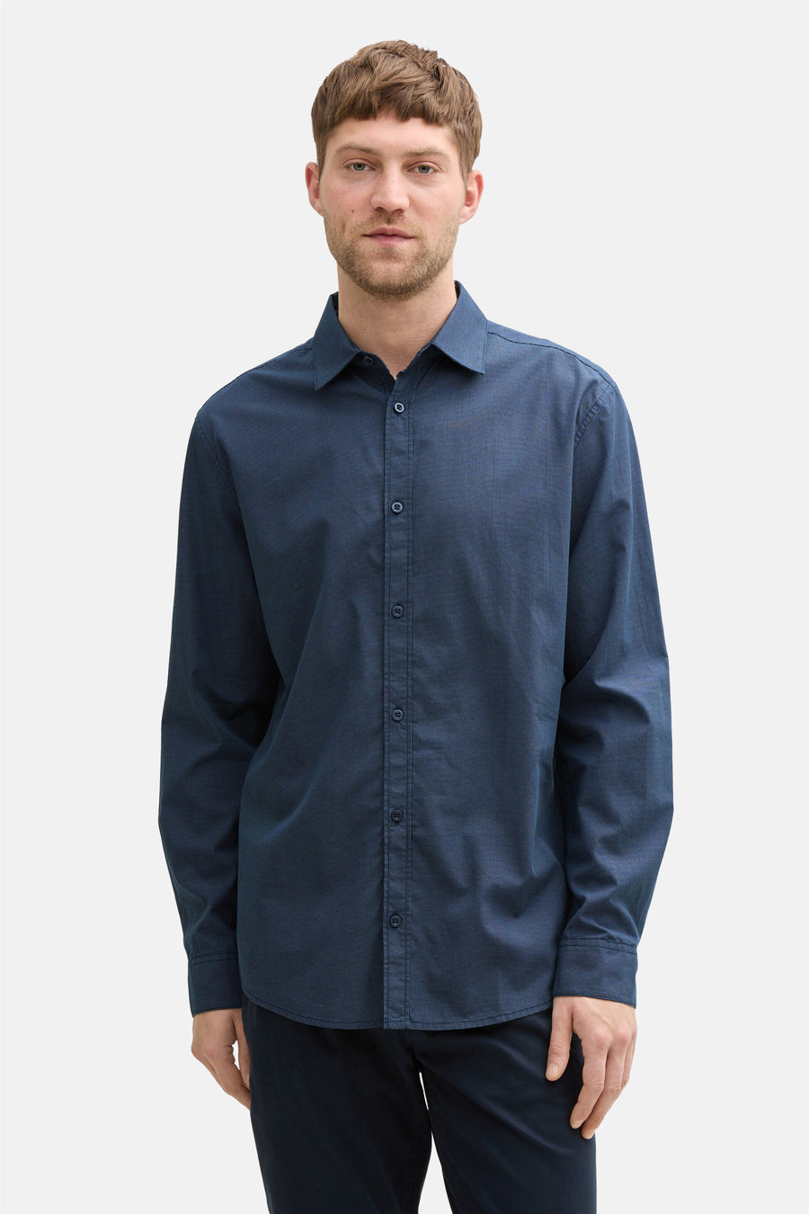 Blauw overhemd met lange mouwen van Tom Tailor, met subtiel patroon, gedragen met een donkere broek.