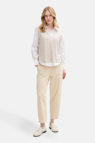 Chino 7/8 beige de Tom Tailor, porté avec un chemisier blanc et des mocassins crème.
