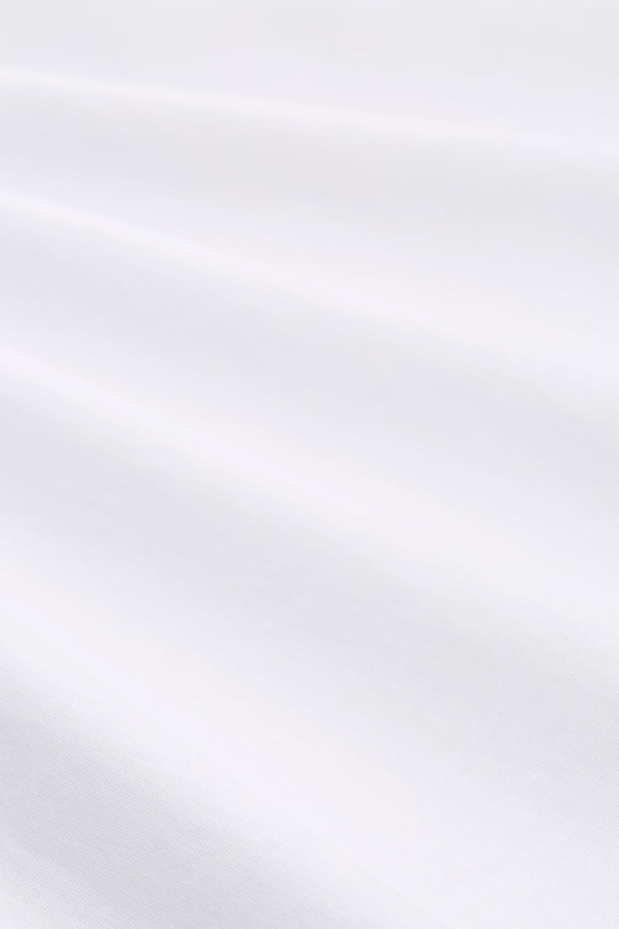 White short-sleeve t-shirt fabric close-up, smooth cotton texture with soft folds and natural sheen