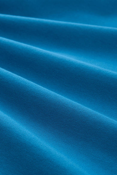 Polo bleu à manches courtes de Tom Tailor, en tissu texturé avec des plis doux.