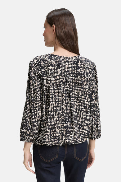 Blouse noire à manches 3/4 de Tom Tailor, avec un motif à pois et des détails froncés.