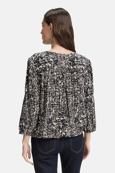 Blouse noire à manches 3/4 de Tom Tailor, avec un motif à pois et des détails froncés.
