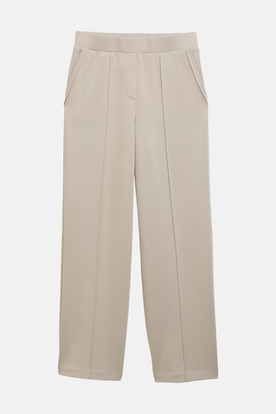 Jogging beige de Tom Tailor, avec poches latérales et plis verticaux sur le devant.