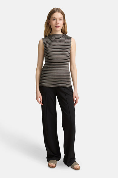 Multikleurig mouwloos topje van Tom Tailor, met horizontale strepen, gedragen met een wijde zwarte broek en sandalen.