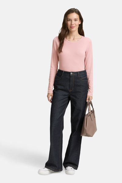 Roze T-shirt met lange mouwen van Tom Tailor, gedragen met een donkere spijkerbroek en een beige handtas.