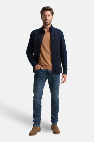 Marineblauwe rits-sweatshirt van Tom Tailor, gedragen met een bruine trui en een spijkerbroek.