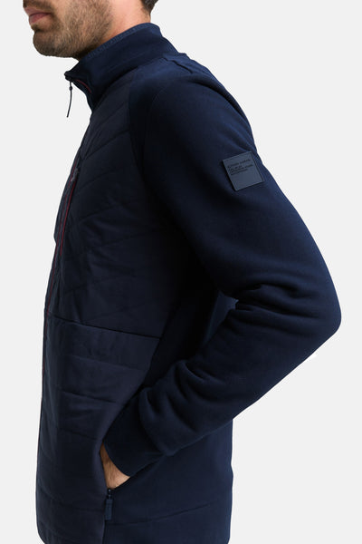 Sweat zippé bleu marine de Tom Tailor, avec empiècement matelassé et patch logo sur la manche.