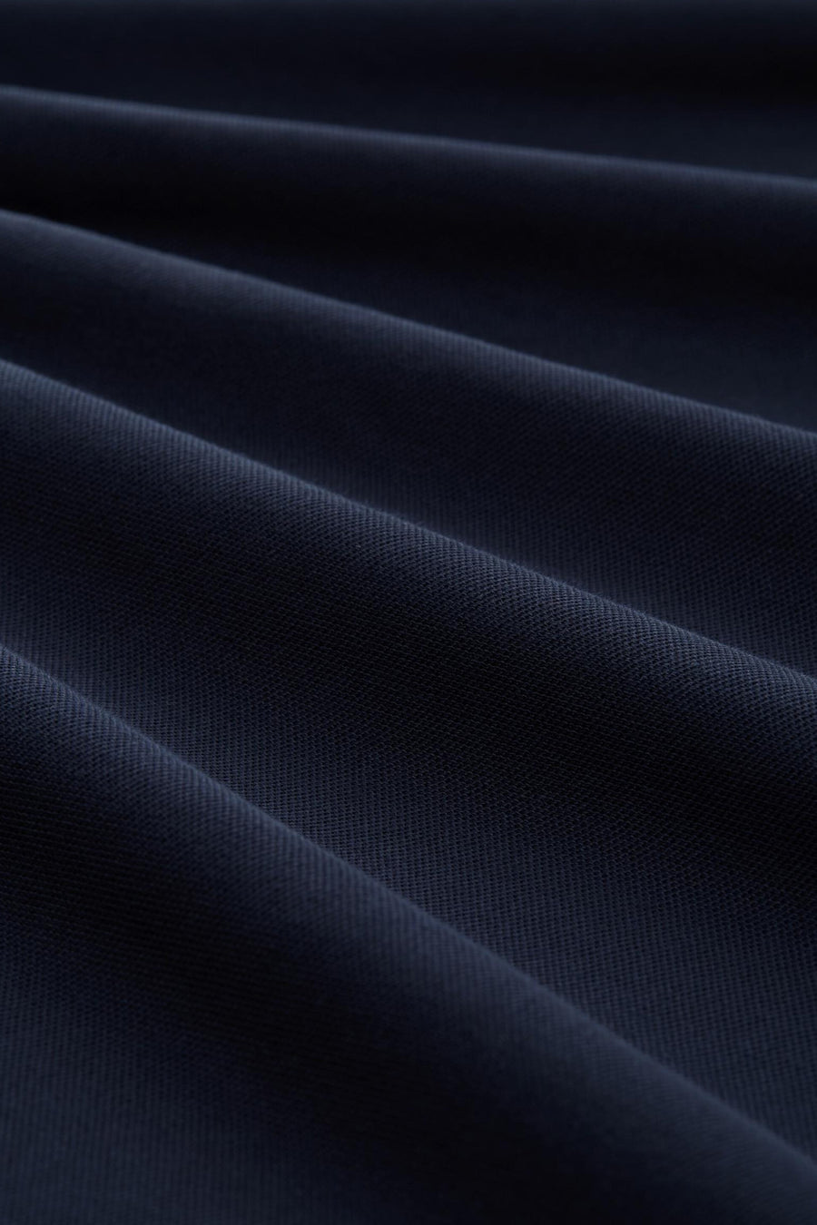 Blauwe polo met korte mouwen van Tom Tailor, met een fijne ribstructuur en zachte plooien.